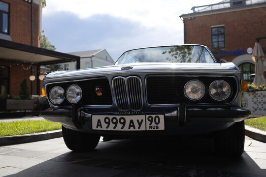Classic luxury vintage coupe bmw e9 silver metallic car at city street auto exhibition under sunlight