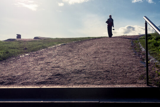 Lone Figure at the Top of a Sunlit Path
