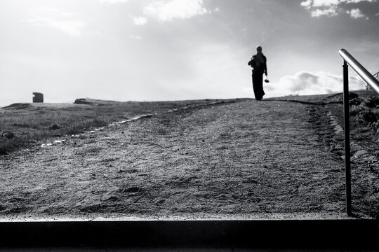 Lone Figure at the Top of a Sunlit Path