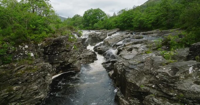 Rushing waterfall cascading over sharp rocks in the forest