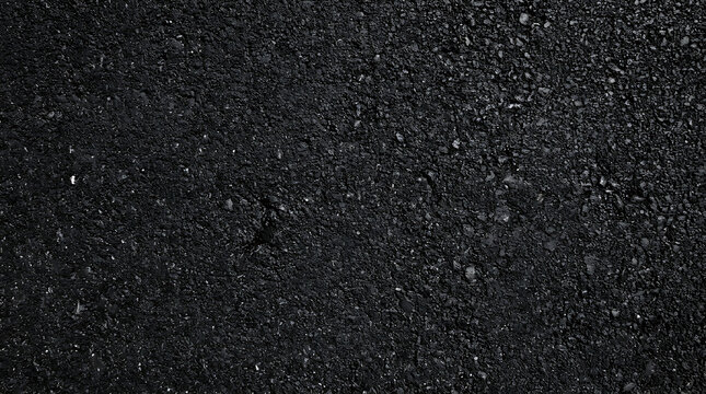 Dark black asphalt seamless background texture with grainy tarmac surface pattern for road construction material and outdoor pavement design element in high resolution top view.