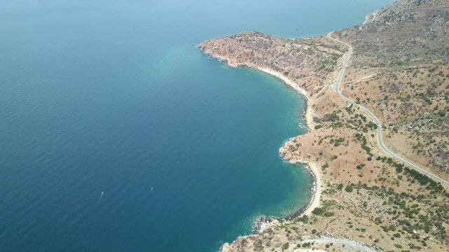 The coastal road in Mui Doi Moi, Ca Na bay, Binh Thuan seen from above with the boulevard and railway, the coast close together is considered a beautiful bay in central Vietnam.