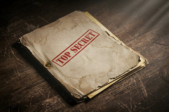 Top Secret Stamped Vintage Old File Folder on Wooden Desk