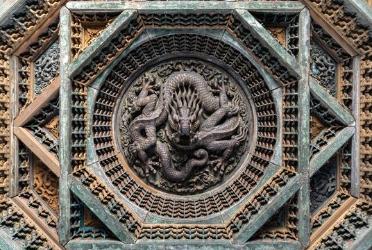 Ancient Chinese wooden caisson ceiling carved in the shape of a Chinese dragon