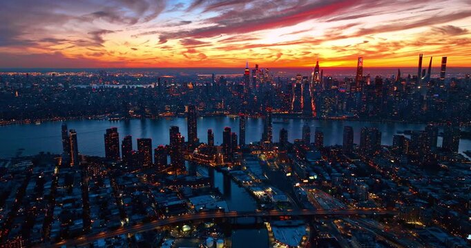 Breath-taking colorful cloudy sky over the metropolis at sunset. Dusk time scenery of New York City, USA from drone.
