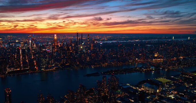 Vast panorama of amazing New York City, USA at sunset. Spectacular multi-colorful sky over metropolis from drone.