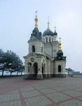 Orthodox Church of Resurrection of Christ features numerous onion-shaped domes topped with golden crosses. Its white walls and dark green roofs reflect its traditional Russian design. Foros, Crimea