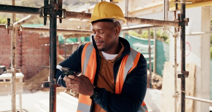 Engineer, man and typing at construction site with phone, scaffolding or check social media on break. Black person, smile and outdoor with tech, text message or building framework for infrastructure.
