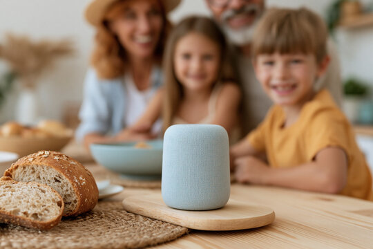 Cozy family gathers around a smart speaker. Children smile, eyes bright with joy. Bread sits invitingly beside the device. Warm light bathes the wooden table. Perfect for home tech or family moments