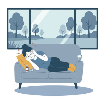 Exhausted woman lying on sofa with headache and medicine