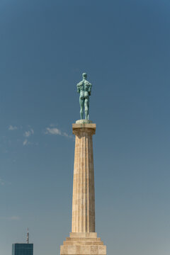 Back view of the Victor Monument Pobednik statue on a high column with Usce Tower in background, Belgrade, Serbia.
