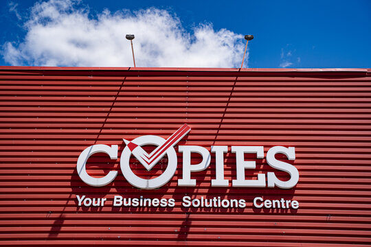 Close up of Copies logo on commercial building exterior. Markham, Canada - May 30, 2026.