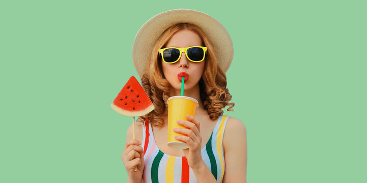 Summer colorful portrait of beautiful young woman drinking juice with lollipop watermelon