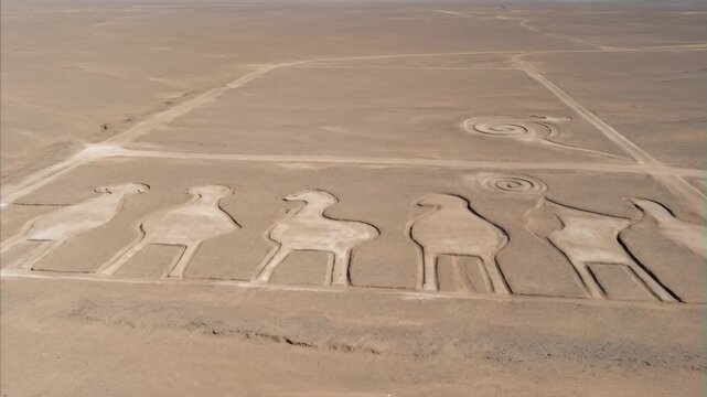 Aerial view of ancient Nazca Lines geoglyphs in vast arid desert landscape of Peru showing stylized animal figures and geometric patterns historical artwork July 28 Peru's Independence Day