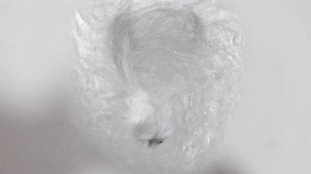 The flushing process in the toilet bowl, close up