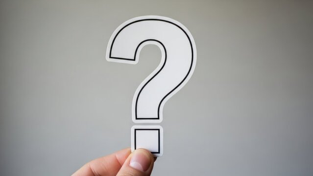 A hand holds a white question mark cutout against a gradient gray background