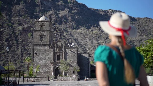 A mature woman smiles at sunrise, excited for her adventure at San Javier Mission in Baja California Sur
