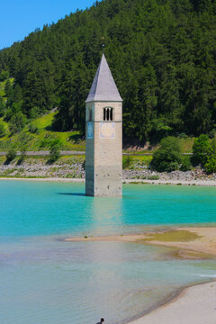 The famous half-submerged bell tower of Curon Venosta (german: Graun im Vinschgau). Lake Reschen,  Southern Tyrol, Italy