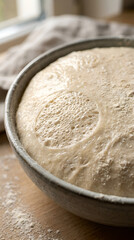 Fototapeta premium Fresh rustic bread dough rising in a ceramic bowl