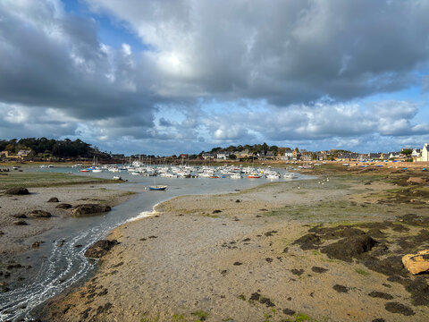 Harbor low tide revealing moored boats in Tregastel Brittany France