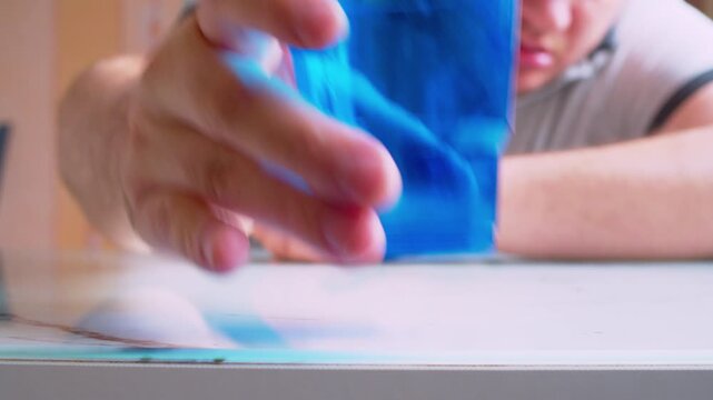 Cinematic close-up of an intoxicated man passing out after aggressively putting down a disposable cup. Defocused background, swaying movement. Soft focus, daylight. Visualizes loneliness and burnout.