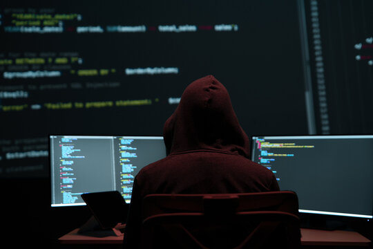 Programmer Hacker Working at Multiple Monitors