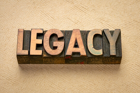 legacy - word in vintage letterpress wood type against art paper