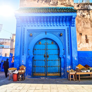 Ornate Blue Door Framed by Traditional Archway in Historic Moroccan Street