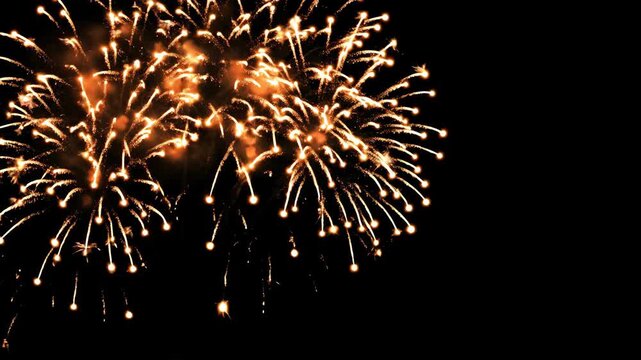 Glowing bursts of light illuminate the night sky with vibrant energy. Explosions create dazzling patterns against a backdrop of darkness