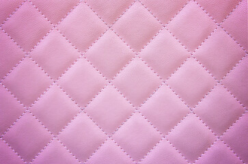 Naklejka premium Soft pink quilted texture with diamond pattern, creating a gentle and elegant background.