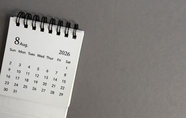 Hello August, desk calendar for planning for August 2026 on a gray background © Елена Николаева