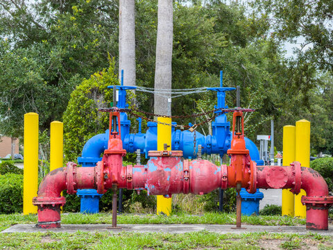 Large outdoor plumbing assembly that protects public drinking water from unintentional contamination in southwest Florida. Motifs of infrastructure, environmental protection, and public health.