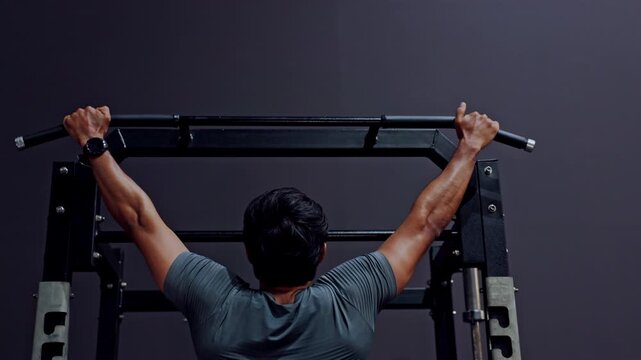 Pull Up Gym Fitness Strength Training Back Muscle Workout Exercise Male Athlete Performing Pull Up Bar Indoors, Rear View Showing Strong Arms Shoulders, Focused Workout Building Endurance