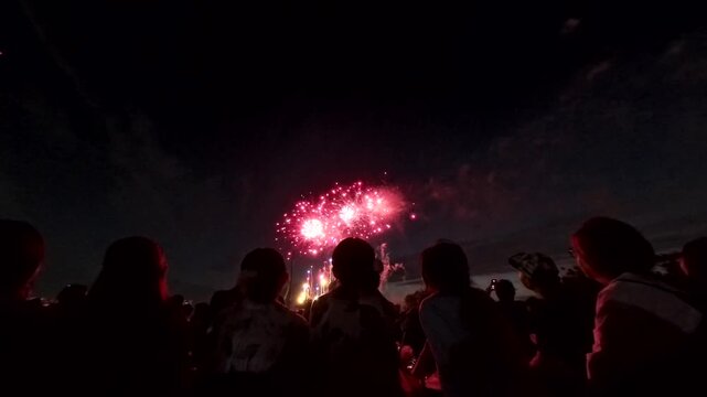 TOKYO, JAPAN - MAY 2026 : View of fireworks and back shot of people. Japanese summer season and festival concept video.
