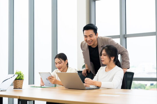 A group of professionals engage in a collaborative meeting in a modern office. The scene highlights teamwork, leadership, dynamic communication in a productive corporate environment.