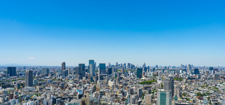 Panoramic Tokyo cityscape with Shibuya, Shinjuku and distant Ikebukuro under blue sky