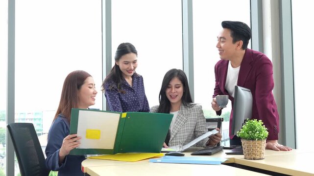 Asian entrepreneur group collaborates in office, fostering teamwork and cooperation to achieve their startup objectives. Their positive partnership drives success, creating a happy and successful job