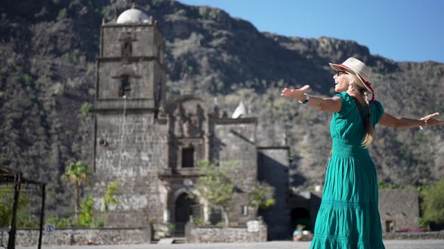 Senior woman enjoys her time exploring San Javier Mission near Loreto during a beautiful sunrise in Baja California Sur, Mexico