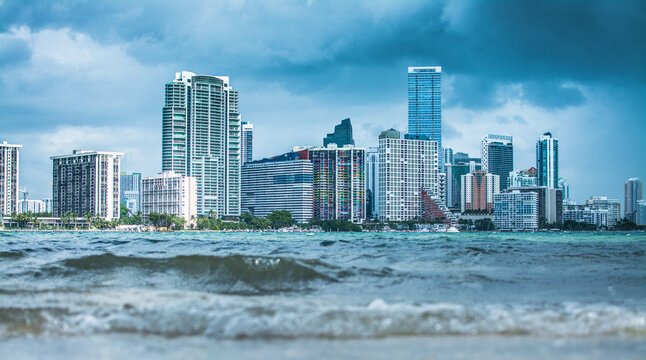 Miami Skyline Viewed From Key Biscayne Beach Across Ocean Waves On Bright Sunny Summer Day