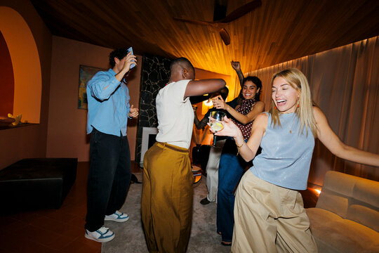 Diverse group of people dancing celebrating at night party