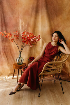 Woman sitting on wicker chair