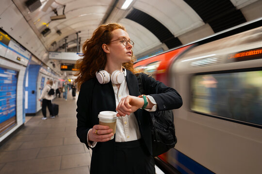 Commuter checking time as train arrives