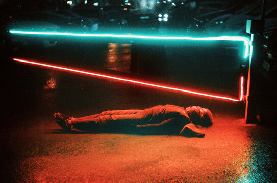 Women lying under neon lights