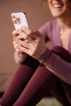 Smiling Woman Relaxed With Smartphone Texting At Home