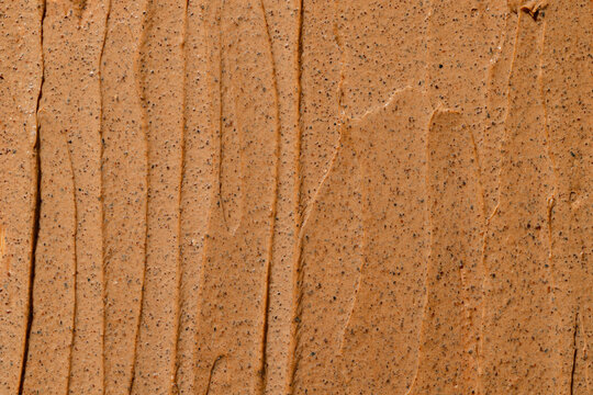 Close-up texture of smooth brown clay with visible fine particles