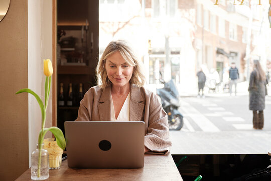 Woman using laptop at a cafe
