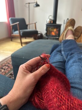 Hand of woman knitting a sweater
