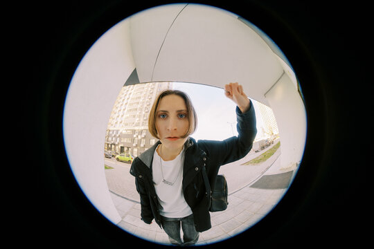 Woman Standing Outside a Building and Knocking on the Door