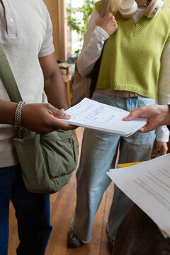 Diverse students exchanging notes in a university library
