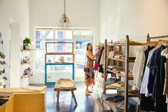 Customer Browses Clothes in a Fashion Shop